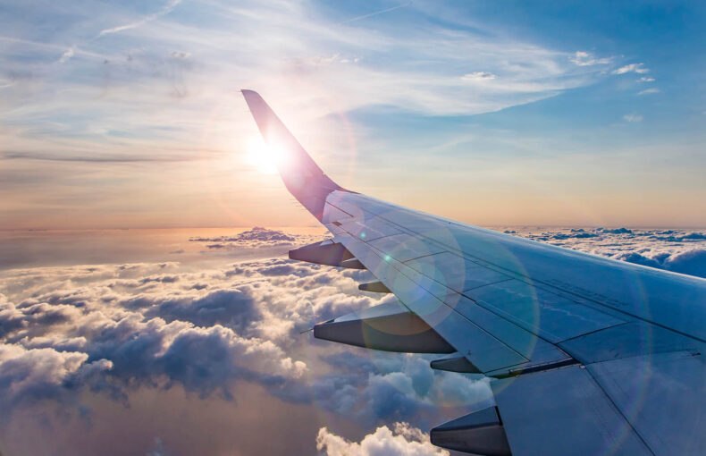 view from airplane window on the wing on sunset time